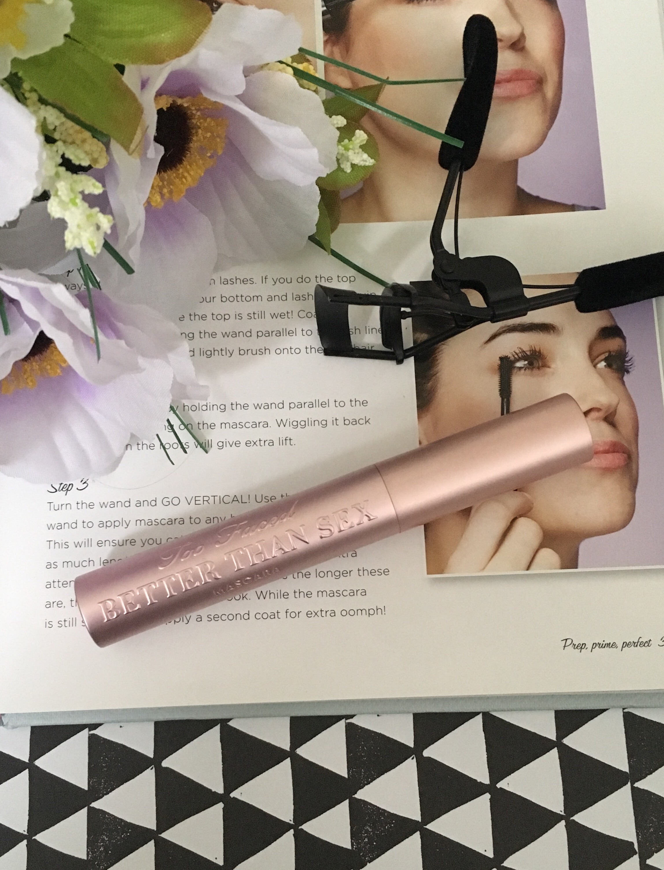 Too-Faced Better Than Sex Mascara with an eyelash curler next to it