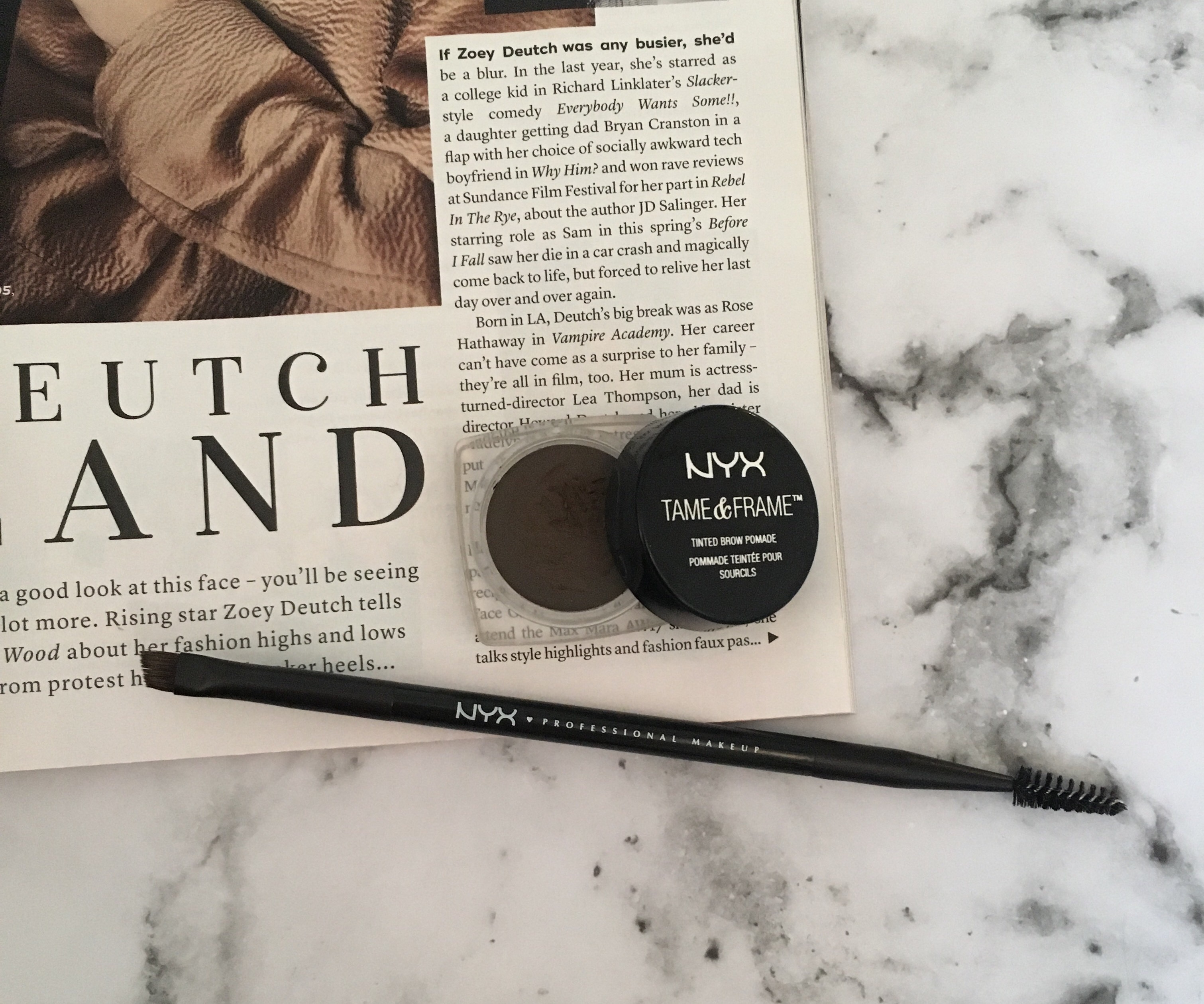 NYX Tame & Frame Eyebrow Pomade with an eyebrow brush and spooley next to it